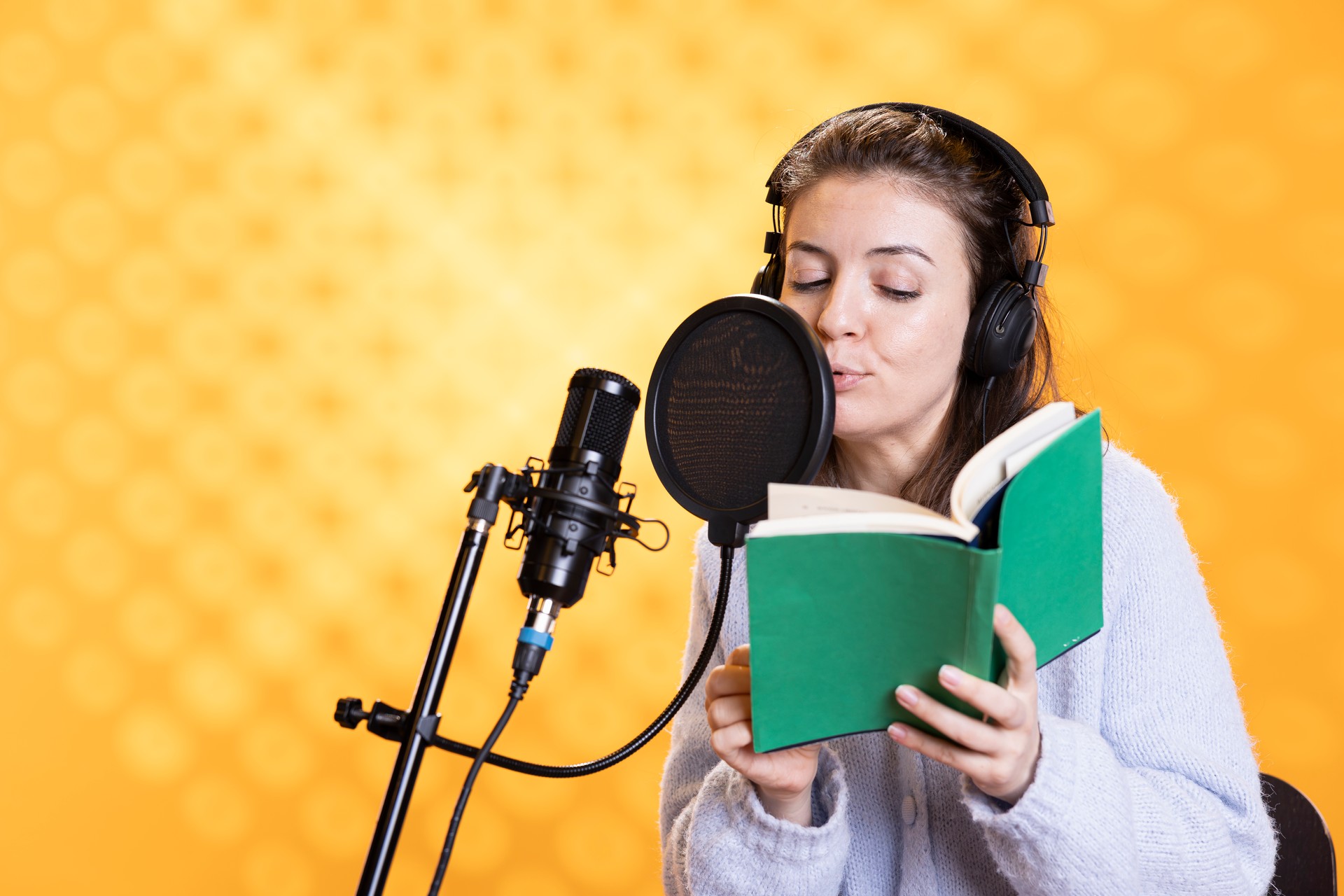 Woman doing voiceover word for word reading of book to produce audiobook